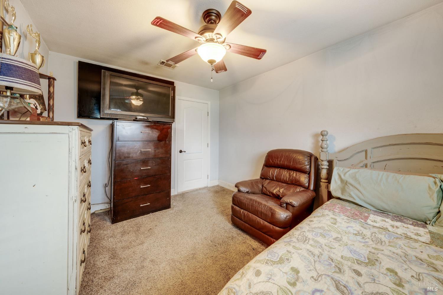 7500 North Meridian Road Vacaville, CA 95688 - Photo 24 of 38 a bedroom with a bed and a television