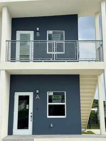 a front view of a house with large windows
