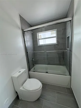 a bathroom with a toilet and a bathtub