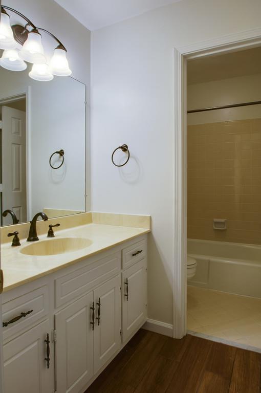 1243 General George Patton Road Nashville, TN 37221 - Photo 18 of 25 a bathroom with a granite countertop sink a mirror and a bathtub