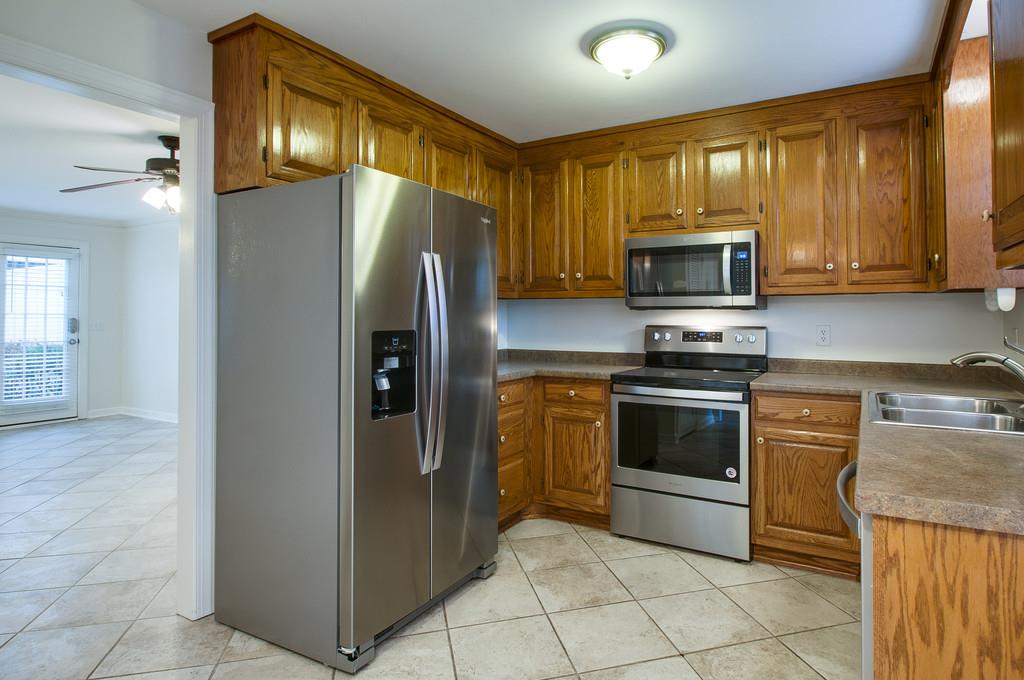 1243 General George Patton Road Nashville, TN 37221 - Photo 5 of 25 a kitchen with stainless steel appliances granite countertop a refrigerator stove and microwave
