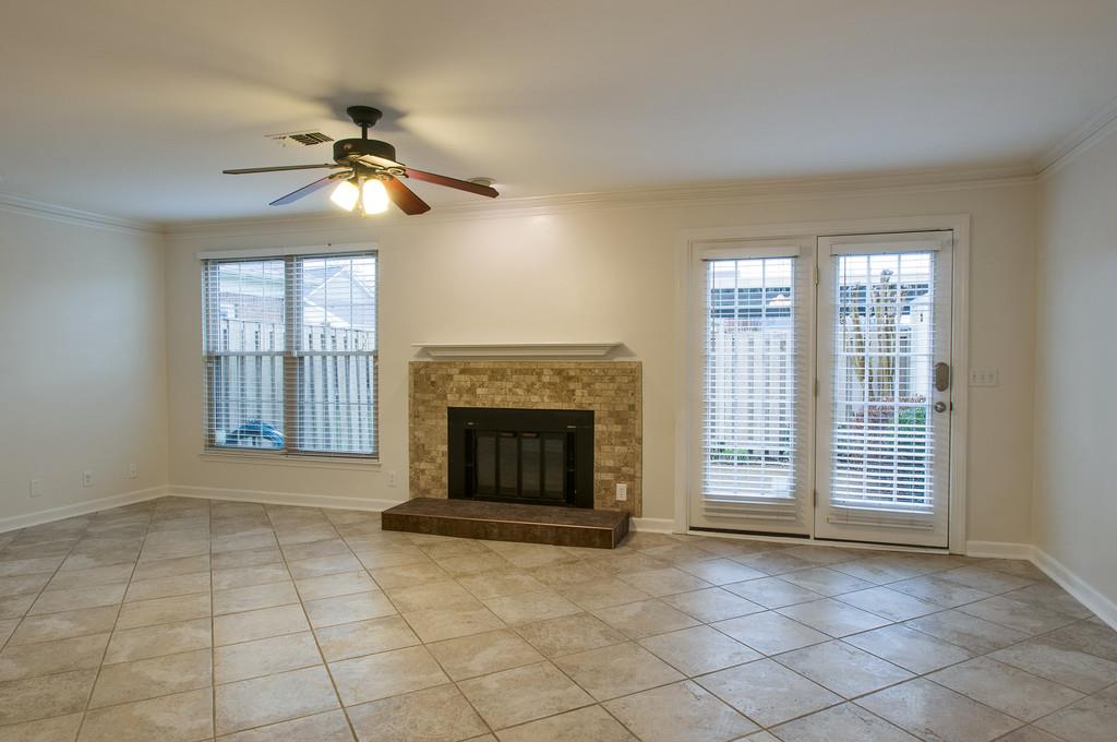 1243 General George Patton Road Nashville, TN 37221 - Photo 7 of 25 an empty room with windows fireplace and fan