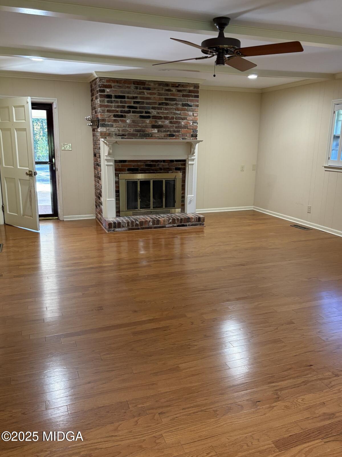 161 Ten Knolls Drive Macon, GA 31210 - Photo 4 of 21 an empty room with wooden floor fireplace and windows