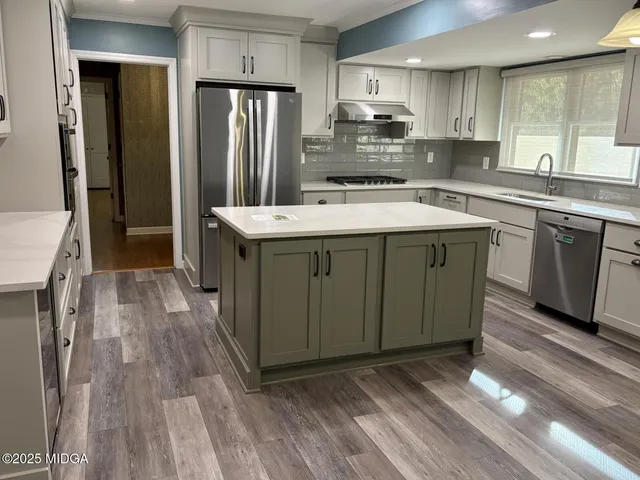a kitchen with a sink stove and refrigerator