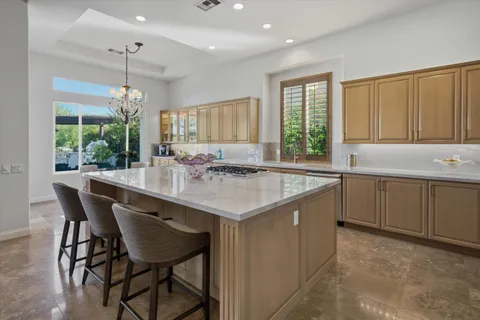 a living room with fireplace furniture and a large window