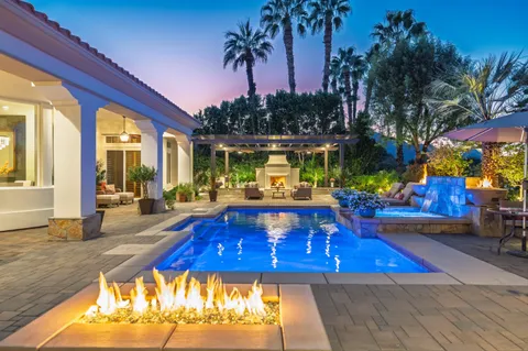 a view of a patio with swimming pool table and chairs