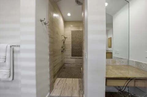 a spacious bedroom with a bed and glass window