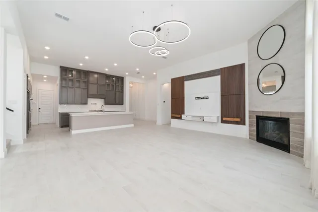 a large white kitchen with a large window and stainless steel appliances