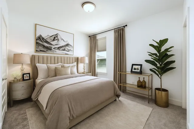 a bedroom with bed and a potted plant