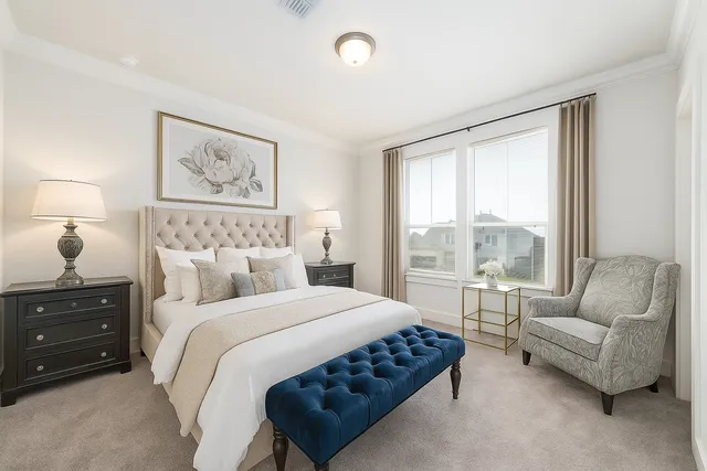 a bedroom with a bed a couch and a window with outer view