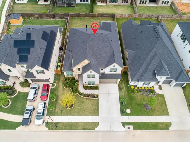 an aerial view of residential houses with outdoor space