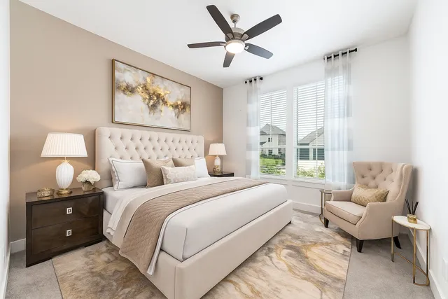 a bedroom with bed and a large window