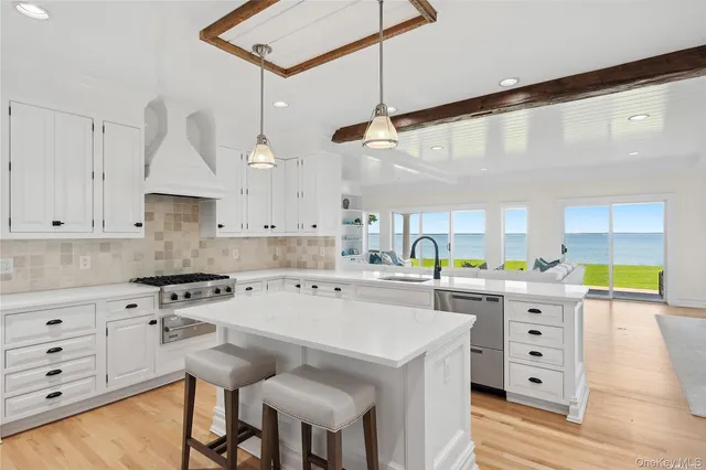 a kitchen with a stove cabinets and wooden floor