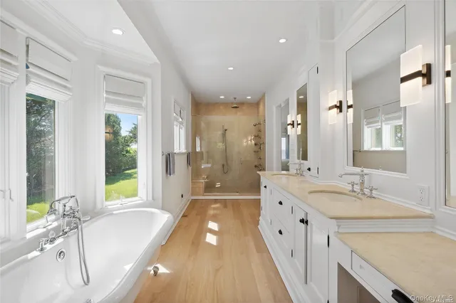 a large spacious bathroom with a granite countertop tub sink and mirror