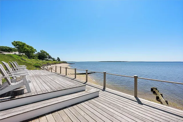 a view of a balcony with wooden floor and furniture