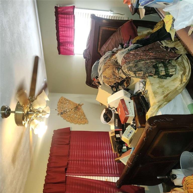 4461 Yates Road College Park, GA 30337 - Photo 1 of 19 a bedroom with furniture and a chandelier