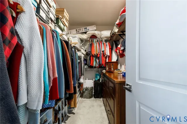 a view of walk in closet with clothes