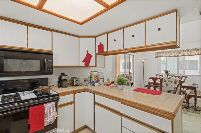 a kitchen with stove a sink and cabinets
