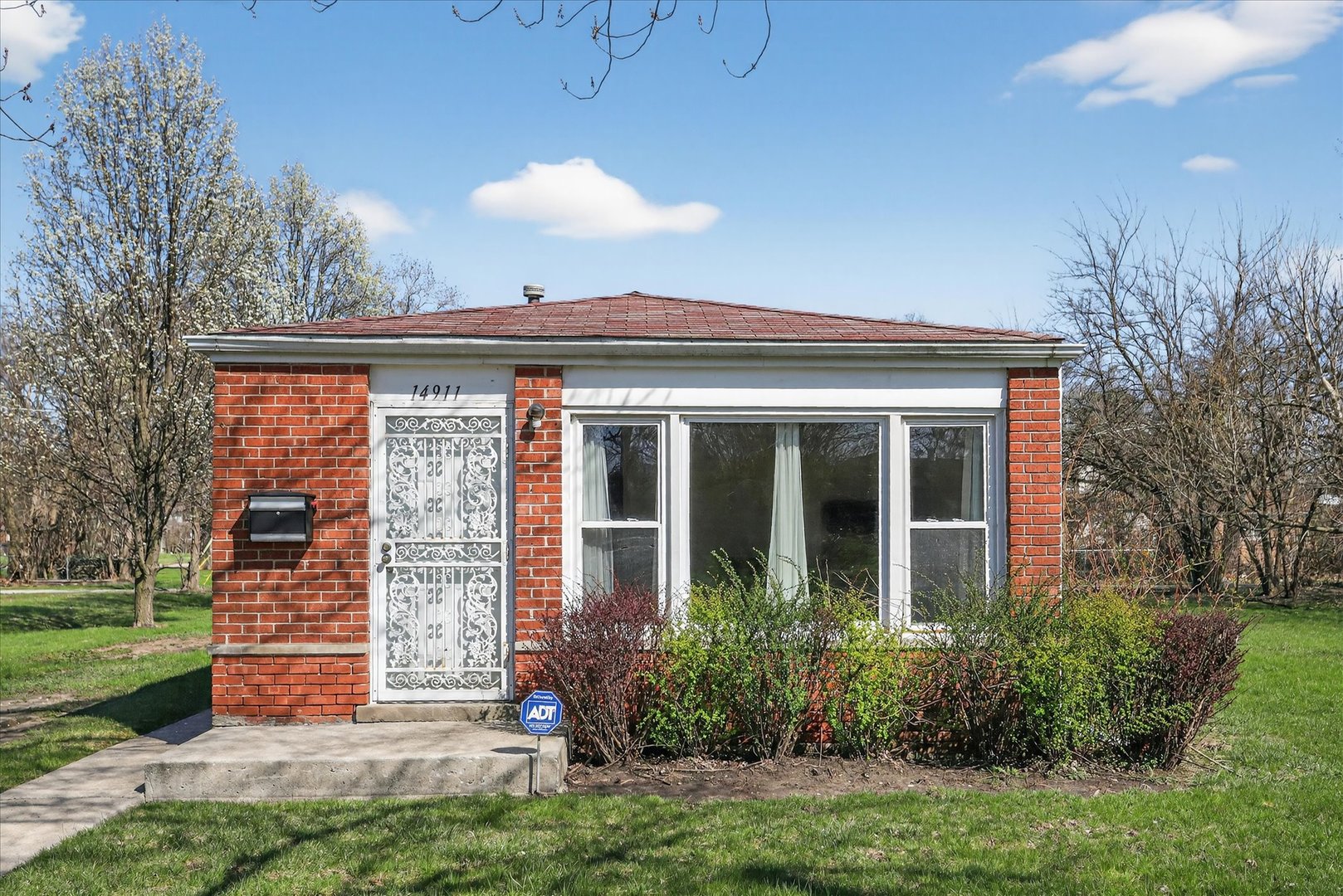 a view of house with backyard and garden