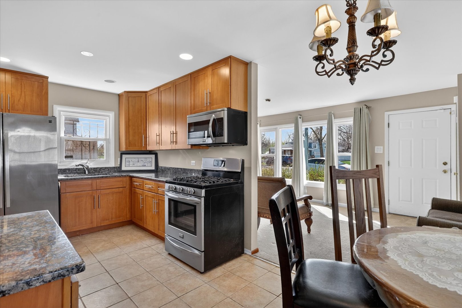 14911 Page Avenue Harvey, IL 60426 - Photo 11 of 35 a kitchen with stainless steel appliances granite countertop a stove top oven a sink dishwasher and a refrigerator