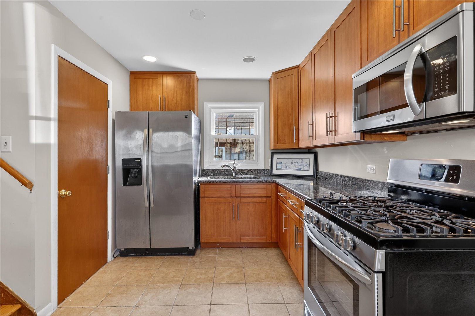 14911 Page Avenue Harvey, IL 60426 - Photo 14 of 35 a kitchen with stainless steel appliances granite countertop a stove a refrigerator and a microwave