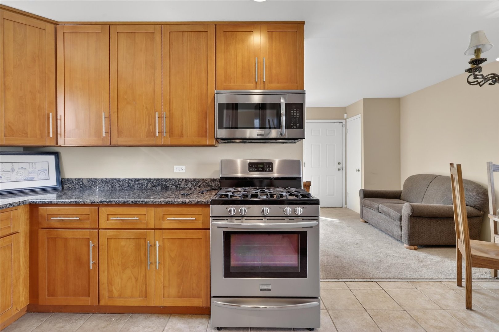 14911 Page Avenue Harvey, IL 60426 - Photo 15 of 35 a kitchen with stainless steel appliances granite countertop a stove top oven microwave and cabinets
