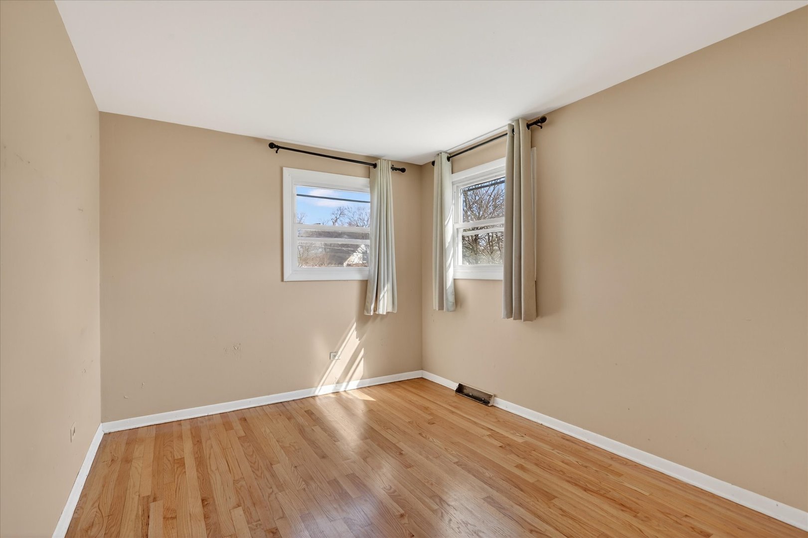 14911 Page Avenue Harvey, IL 60426 - Photo 19 of 35 an empty room with wooden floor and windows