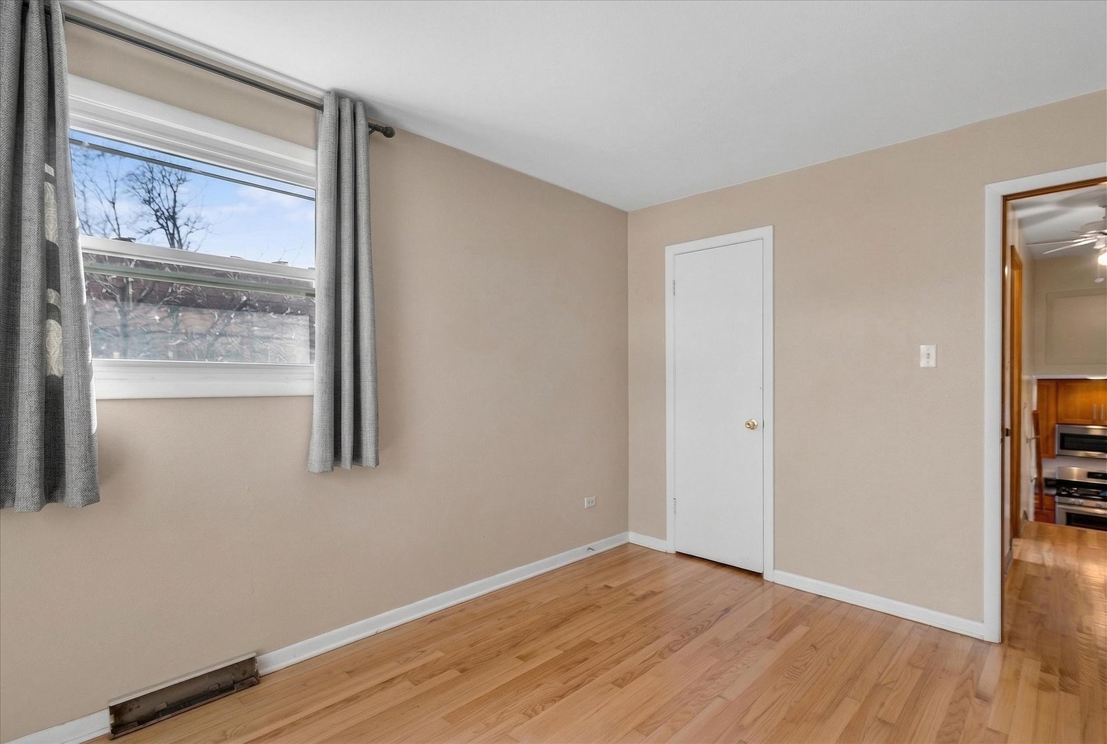 14911 Page Avenue Harvey, IL 60426 - Photo 20 of 35 a view of an empty room with wooden floor and a window