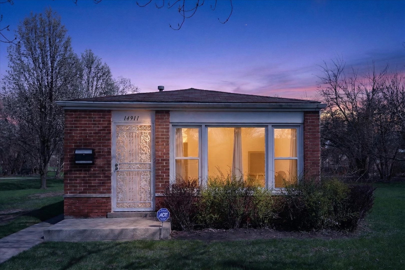 14911 Page Avenue Harvey, IL 60426 - Photo 2 of 35 a front view of a house with a yard