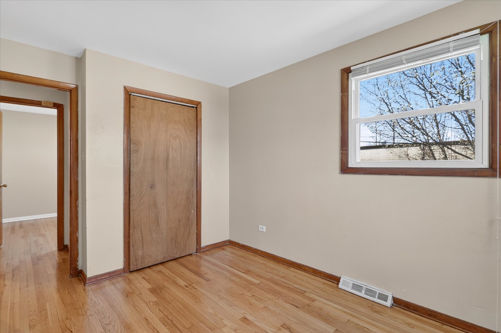 14911 Page Avenue Harvey, IL 60426 - Photo 22 of 35 a view of an empty room with wooden floor and a window