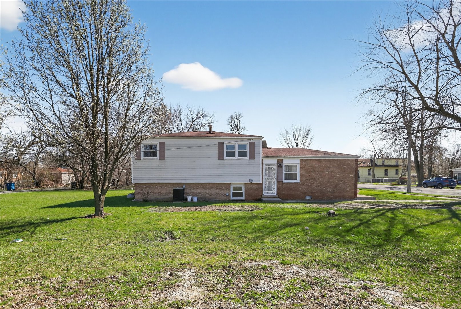 14911 Page Avenue Harvey, IL 60426 - Photo 34 of 35 a view of a house with a big yard and large trees