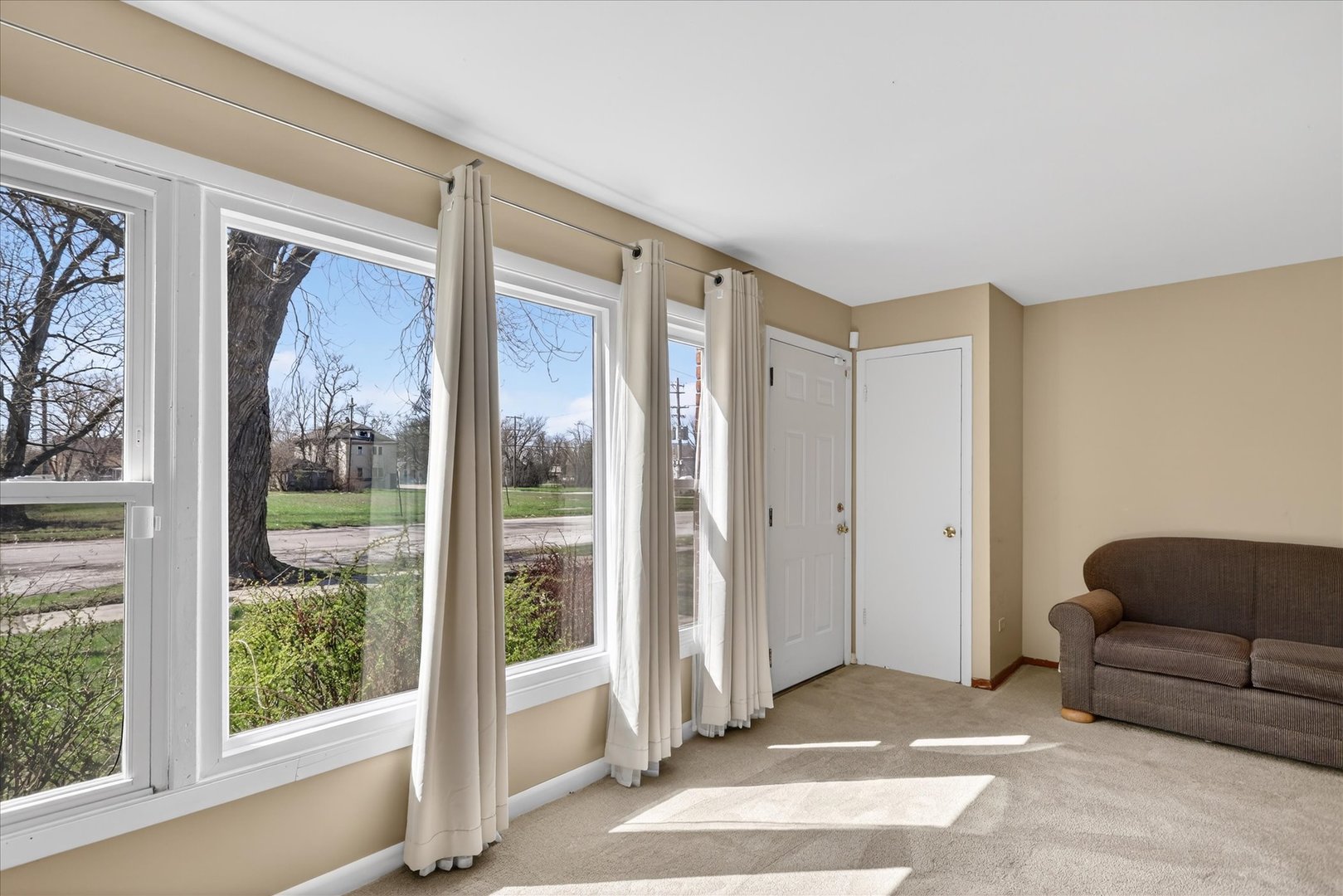 14911 Page Avenue Harvey, IL 60426 - Photo 6 of 35 a living room with furniture and a floor to ceiling window