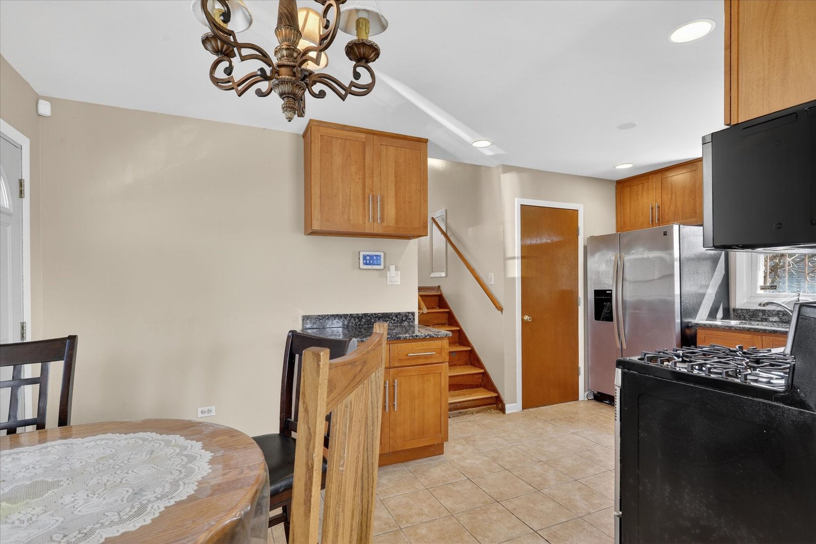 14911 Page Avenue Harvey, IL 60426 - Photo 10 of 35 a view of a livingroom with furniture and staircase