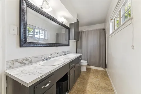 a bathroom with a sink a vanity and a mirror