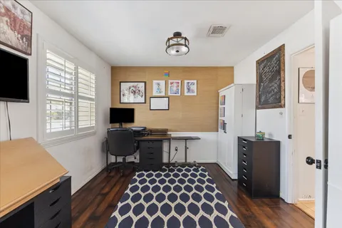 a view of empty room with wooden floor