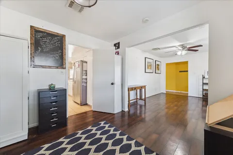 a view of empty room with wooden floor