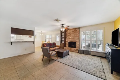 a living room with furniture a flat screen tv and a fireplace