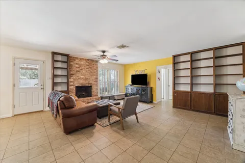 a living room with furniture a flat screen tv and a fireplace