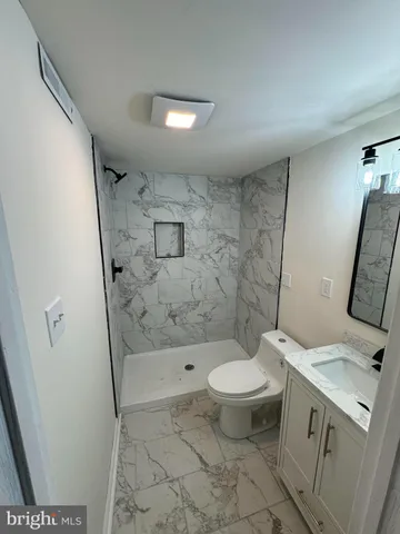 a view of room with a ceiling fan and wooden floor