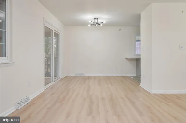 a kitchen with cabinets appliances and a window