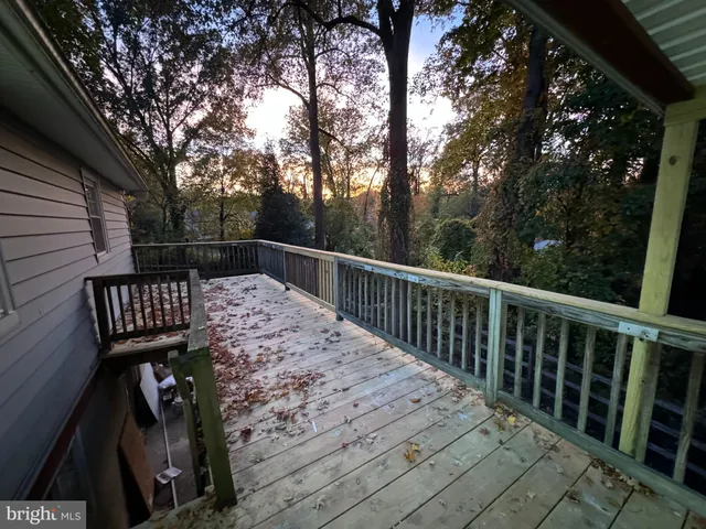 a view of balcony with wooden floor and fence