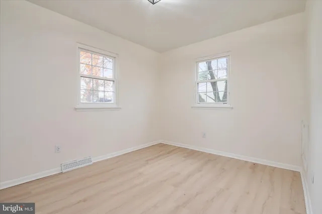a bathroom with a granite countertop toilet sink and mirror