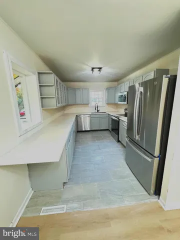 a kitchen with a refrigerator and a sink