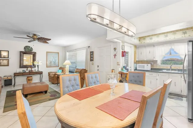 a dining room with wooden floor and white walls