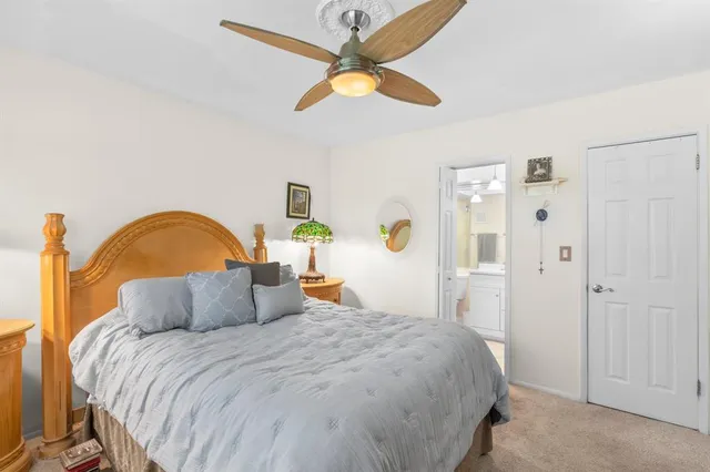 a bedroom with a bed and ceiling fan
