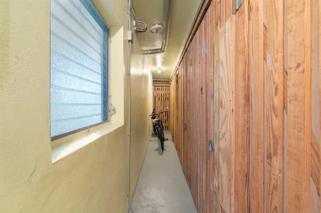 a view of a hallway with wooden shelves