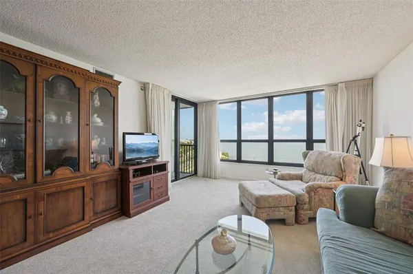 a view of a dining room with furniture and chandelier