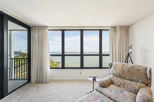 a kitchen with stainless steel appliances granite countertop a sink a stove a refrigerator cabinets a dining table and chairs