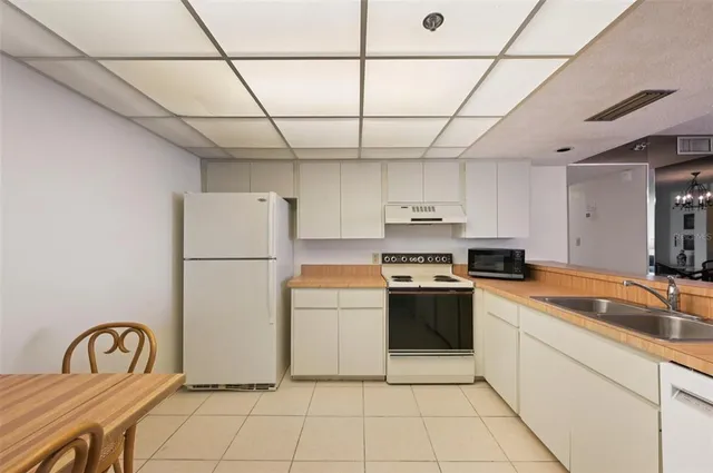 a bedroom with a bed and a lamp next to a window