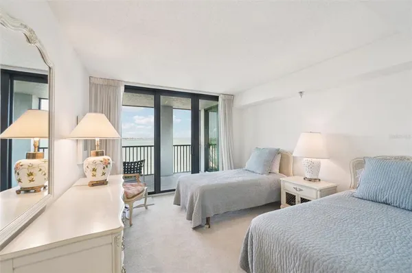 a view of a building with a yard and sitting area